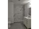 Bathroom with a decorative white tiled shower and a white sink vanity with gold fixtures at 148 Lake Otis Rd, Winter Haven, FL 33884