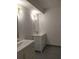 Modern bathroom with double sink vanity, white cabinets, gold fixtures, and gray tiled flooring at 148 Lake Otis Rd, Winter Haven, FL 33884