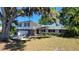 Charming two-story brick home with attached garage and mature trees at 148 Lake Otis Rd, Winter Haven, FL 33884