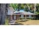 Close up front elevation of brick home with a manicured yard at 148 Lake Otis Rd, Winter Haven, FL 33884