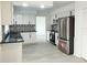 Updated kitchen featuring stainless steel appliances and black and white backsplash at 148 Lake Otis Rd, Winter Haven, FL 33884