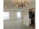 Bright living room with modern lighting, neutral walls, and wood-look floors at 148 Lake Otis Rd, Winter Haven, FL 33884