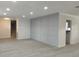 Inviting open-concept living space featuring new floors, recessed lights, staircase and modern gray accent wall at 148 Lake Otis Rd, Winter Haven, FL 33884