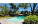 Refreshing in-ground pool with lush landscaping providing a private oasis at 148 Lake Otis Rd, Winter Haven, FL 33884