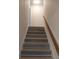Staircase with wood railing leading to the upper level at 148 Lake Otis Rd, Winter Haven, FL 33884