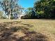 Expansive vacant lot featuring a two-story brick home at 148 Lake Otis Rd, Winter Haven, FL 33884