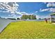 Beautiful, verdant back lawn enclosed with modern, white fencing at 1510 Shorewood Dr, Auburndale, FL 33823