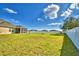 Spacious fenced backyard featuring a lush green lawn and an open view at 1510 Shorewood Dr, Auburndale, FL 33823