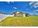 Lush green backyard with a white fence, featuring ample space for outdoor enjoyment at 1510 Shorewood Dr, Auburndale, FL 33823