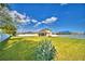 Expansive backyard featuring lush green grass and a white picket fence for privacy at 1510 Shorewood Dr, Auburndale, FL 33823