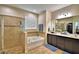Elegant bathroom featuring a soaking tub, separate shower, and dual vanity sinks with modern fixtures at 1510 Shorewood Dr, Auburndale, FL 33823