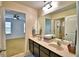 Bathroom boasts a dual sink vanity and seamless connection to the bedroom at 1510 Shorewood Dr, Auburndale, FL 33823