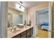 Bathroom features a dual sink vanity and convenient access to other areas of the house at 1510 Shorewood Dr, Auburndale, FL 33823