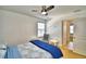 Comfortable bedroom featuring a ceiling fan, neutral carpeting, and a sunny window for ample light at 1510 Shorewood Dr, Auburndale, FL 33823