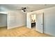 Carpeted bedroom with ceiling fan, bathroom access, and white walls at 1510 Shorewood Dr, Auburndale, FL 33823