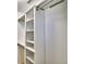 Organized walk-in closet featuring built-in shelves and clothing rods at 1510 Shorewood Dr, Auburndale, FL 33823