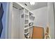 Walk-in closet with white shelving and room for storage at 1510 Shorewood Dr, Auburndale, FL 33823
