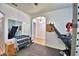 A dedicated home gym, including free weights, a weight machine, a treadmill, and rubber flooring at 1510 Shorewood Dr, Auburndale, FL 33823
