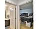 Hallway view into bathroom and office space with multiple monitors at 1510 Shorewood Dr, Auburndale, FL 33823