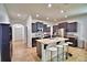 Bright kitchen with stainless steel appliances, island with seating, and dark cabinetry at 1510 Shorewood Dr, Auburndale, FL 33823