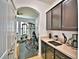 Kitchen area adjacent to the home gym with dark wood cabinets and beige countertops at 1510 Shorewood Dr, Auburndale, FL 33823