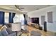 Bright living room with modern entertainment system, plush seating, and large windows at 1510 Shorewood Dr, Auburndale, FL 33823