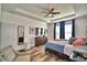 Bright main bedroom with wood flooring, tray ceilings, dresser, and comfortable furnishings at 1510 Shorewood Dr, Auburndale, FL 33823