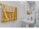 Bathroom featuring modern fixtures, a pedestal sink, and a decorative towel arrangement at 177 Piave St, Haines City, FL 33844