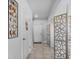 Hallway with decorative screen, artwork, and tiled floor leading to the front door at 177 Piave St, Haines City, FL 33844