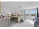 Bright main bedroom featuring large windows, neutral colors, and a cozy seating area at 177 Piave St, Haines City, FL 33844