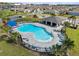 Community pool area with ample lounge chairs, a covered pavilion, and a secure fence surrounded by palm trees at 177 Piave St, Haines City, FL 33844