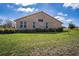 Back exterior view of the home with a brick facade and well-maintained landscaping at 1815 Adams Barn Rd, Lake Alfred, FL 33850