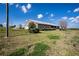 Back exterior view of the brick home with a large yard and screened-in porch at 1815 Adams Barn Rd, Lake Alfred, FL 33850