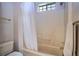 Bathroom featuring a shower-tub combo, and a small window allowing natural light in the space at 1815 Adams Barn Rd, Lake Alfred, FL 33850