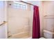 Bathroom with a shower-tub combo, a small window, and a peach-colored shower curtain at 1815 Adams Barn Rd, Lake Alfred, FL 33850
