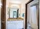 Bathroom featuring a shower-tub combo, a vanity with a granite top and wooden fixtures at 1815 Adams Barn Rd, Lake Alfred, FL 33850