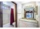 Well-lit bathroom featuring a shower-tub combo, a granite vanity and unique wall paper at 1815 Adams Barn Rd, Lake Alfred, FL 33850