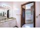 Bright bathroom featuring a vanity with granite countertops, cabinet storage and access to a bathtub room at 1815 Adams Barn Rd, Lake Alfred, FL 33850