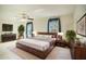 Comfortable bedroom with a plush rug, ceiling fan and natural light from the two windows at 1815 Adams Barn Rd, Lake Alfred, FL 33850