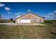 Exterior view of brick home showing garage and yard at 1815 Adams Barn Rd, Lake Alfred, FL 33850