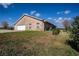 Exterior view of the brick home with a two-car attached garage at 1815 Adams Barn Rd, Lake Alfred, FL 33850
