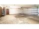 Spacious two-car garage with painted walls, open shelving, and an indoor-outdoor rug at 1815 Adams Barn Rd, Lake Alfred, FL 33850