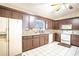 Well-lit kitchen with tile flooring, and a granite countertop breakfast bar at 1815 Adams Barn Rd, Lake Alfred, FL 33850