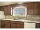 Kitchen featuring wood cabinets, granite countertops, and a window view at 1815 Adams Barn Rd, Lake Alfred, FL 33850