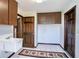 Utility room with overhead cabinets, a utility sink, and three wooden doors at 1815 Adams Barn Rd, Lake Alfred, FL 33850