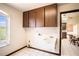 Functional laundry room with cabinet storage and natural light at 1815 Adams Barn Rd, Lake Alfred, FL 33850