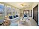 Bright sunroom with comfortable seating and large windows at 1815 Adams Barn Rd, Lake Alfred, FL 33850