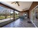 Covered patio with dining and seating area, overlooking a landscape with mature trees at 1815 Adams Barn Rd, Lake Alfred, FL 33850