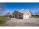 Side view of the brick house showing attached garage and driveway at 1815 Adams Barn Rd, Lake Alfred, FL 33850