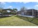View of the backyard featuring a screened-in pool and detached shelter at 1817 Mckeown Ave, Haines City, FL 33844